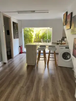 a kitchen with a table and two stools at Modern City Center Appartment Saripolou in Limassol