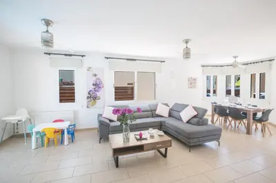 a living room with a couch and a table at Ariella Villa in Protaras