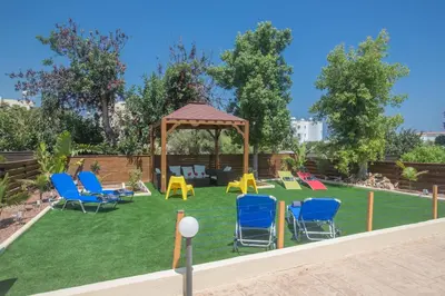 a yard with chairs and a gazebo at Ariella Villa in Protaras