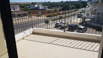 a balcony with a view of a parking lot at BarLee's Apartment in Paralimni