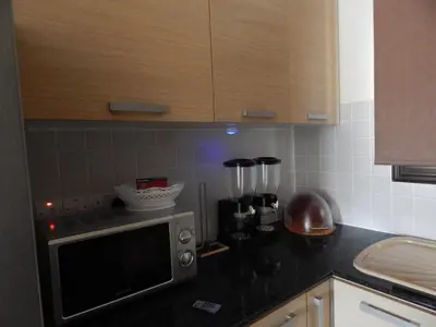 a kitchen with a microwave on a counter at BarLee's Apartment in Paralimni