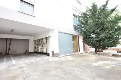 a large white building with a tree in front of it at Glabur Stays - The Amazing 1 BDR - Executive apt Nicosia Center Free Parking & WiFi in Nicosia