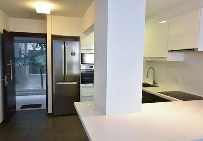 a kitchen with a stainless steel refrigerator in it at Glabur Stays - The Amazing 1 BDR - Executive apt Nicosia Center Free Parking & WiFi in Nicosia