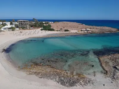 an aerial view of a beach with a group of chairs at Nissi Avenue 64 Studio 1 - Luxcyservices in Ayia Napa