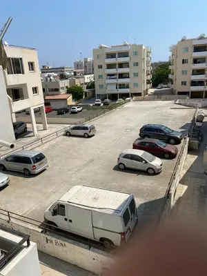 a group of cars parked in a parking lot at City Comfort Rooms in Larnaka