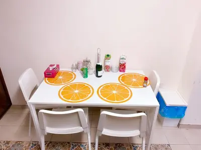a white table with orange slices on it at City Comfort Rooms in Larnaka
