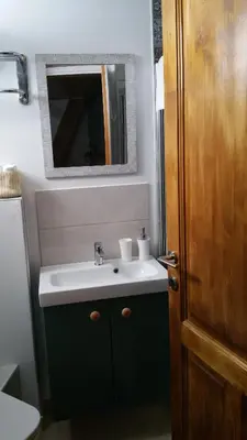 a bathroom with a sink and a mirror at Magdalene's City House Inn in Larnaka