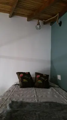 a bedroom with a bed with two pillows on it at Magdalene's City House Inn in Larnaka