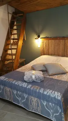 a bedroom with a bed with a staircase in the background at Magdalene's City House Inn in Larnaka