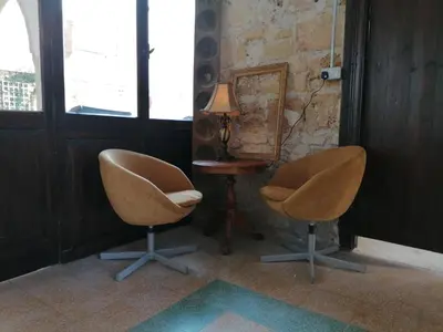 two chairs in a room with a table and a lamp at Le Mat Hostel in Larnaka