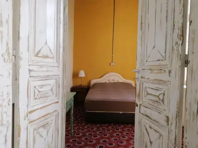 an open door to a bedroom with a bed at Le Mat Hostel in Larnaka
