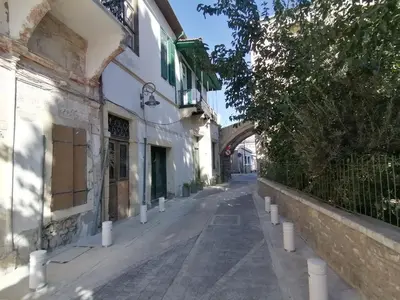 an empty street in a town with a building at Le Mat Hostel in Larnaka