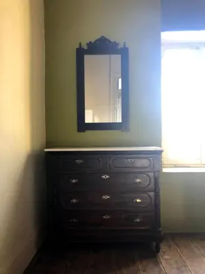 a dresser with a mirror in a room at Le Mat Hostel in Larnaka