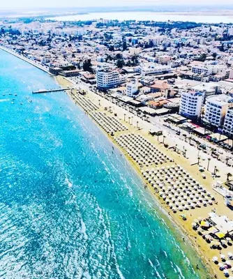 an aerial view of a beach with buildings and the ocean at Kareem flat in Larnaka