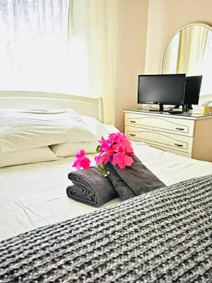a bedroom with a bed with flowers on it at Kareem flat in Larnaka