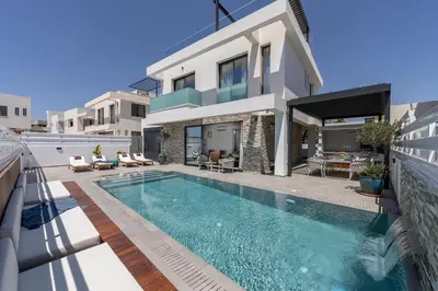 a house with a swimming pool in front of a house at Chris Le Mare Gold Luxury Villa in Protaras