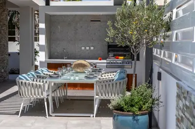 an outdoor dining area with a table and chairs at Chris Le Mare Gold Luxury Villa in Protaras