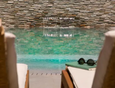 a pair of glasses sitting on a table next to a pool at Chris Le Mare Gold Luxury Villa in Protaras