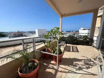 a balcony with potted plants on a building at Topikos Apartments in Ayia Napa