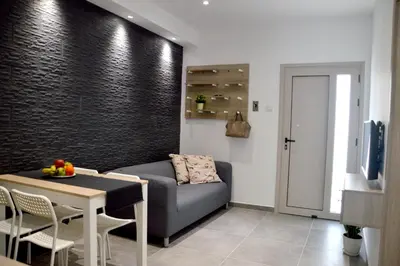 a living room with a couch and a table at Topikos Apartments in Ayia Napa