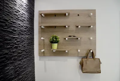 a plant in a pot on a wall with a purse at Topikos Apartments in Ayia Napa