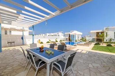 a patio with a table and chairs on a patio at Mylos Lifestyle Seaview Villa #21 in Protaras