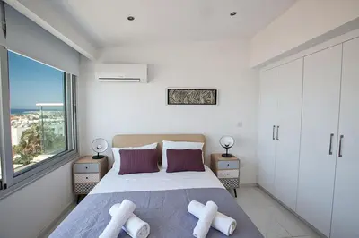 a bedroom with a large bed and a large window at Apt Misia Enas - Modern 2 Bedroom Apartment With Sea Views - Close To Ayia Napa in Ayia Napa