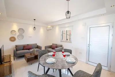 a living room with a table and chairs at Apt Misia Enas - Modern 2 Bedroom Apartment With Sea Views - Close To Ayia Napa in Ayia Napa