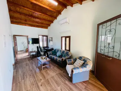 a living room with two couches and a table at Lovely house not far from the beach, near Protaras in Dherinia