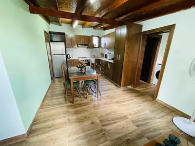 a kitchen and dining room with a table and chairs at Lovely house not far from the beach, near Protaras in Dherinia