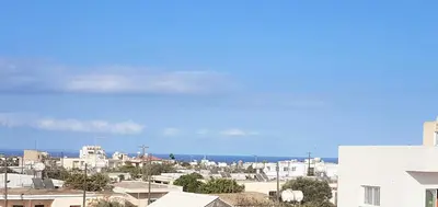 a city with buildings and the ocean in the background at Lovely house not far from the beach, near Protaras in Dherinia
