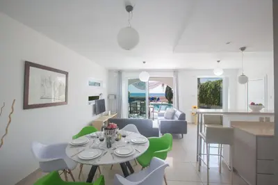 a kitchen and living room with a table and chairs at Sunrise Villa 12 in Ayia Napa