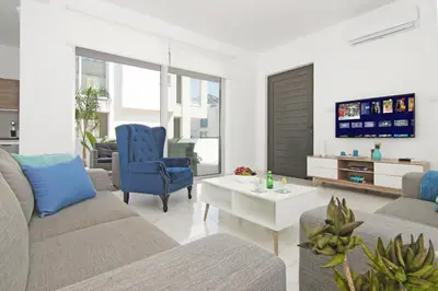 a living room with a couch and a tv at Villa Greta in Protaras