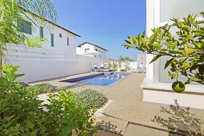 a villa with a swimming pool and a house at Villa Greta in Protaras
