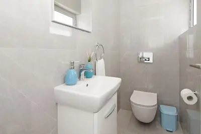 a white bathroom with a sink and a toilet at Villa Luna in Protaras