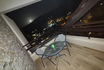 two chairs on a balcony with a view of the city at Kakopetria Heights in Kakopetria