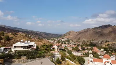 a view of a town in the mountains at Kakopetria Heights in Kakopetria
