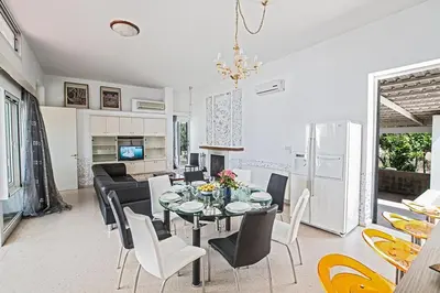 a dining room and kitchen with a table and chairs at Villa Mavris - Lovely 4 Bedroom Villa With Private Pool In Central Ayia Napa in Ayia Napa