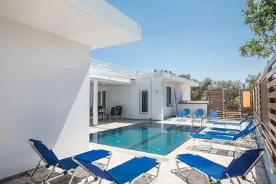 a swimming pool with blue chairs and a house at Villa Mavris - Lovely 4 Bedroom Villa With Private Pool In Central Ayia Napa in Ayia Napa