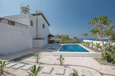 a house with a swimming pool next to a building at Villa Nepou - Beautiful 4 Bedroom Villa - Located In Ayia Napa in Ayia Napa