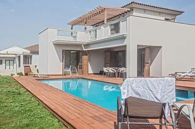 a villa with a swimming pool and a house at Villa Petreris Dyo - Lovely 3 Bedroom Central Ayia Napa Villa With Pool in Ayia Napa