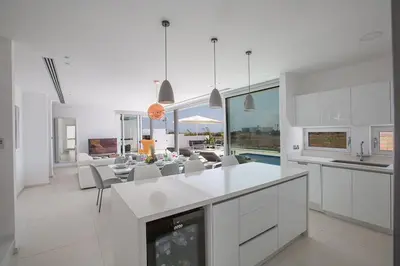 a kitchen and living room with a table and chairs at Villa Manta Agrotikos - Stunning 3 Bedroom Protaras Villa With Pool in Protaras