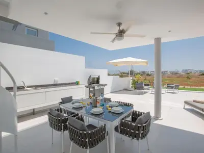 a dining room with a table and chairs at Villa Manta Agrotikos - Stunning 3 Bedroom Protaras Villa With Pool in Protaras
