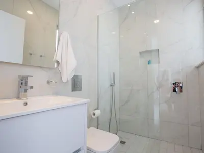 a bathroom with a shower and a toilet and a sink at Villa Manta Agrotikos - Stunning 3 Bedroom Protaras Villa With Pool in Protaras