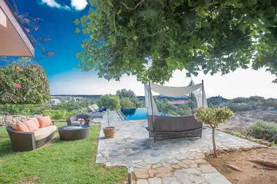 a backyard with a hammock and chairs and a pool at Villa Ayia Napa Foothills, Exquisite 5Bdr Ayia Napa Villa With Pool in Ayia Napa