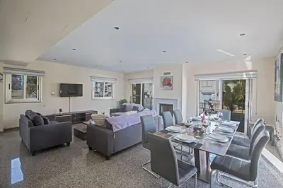 a living room with a table and chairs at Villa Dafnis Platina - Lovely 4 Bedroom Protaras Villa With Private Pool in Protaras