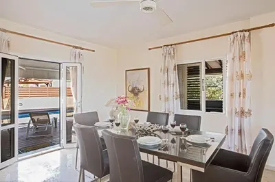 a dining room with a glass table and chairs at Villa Magusta - Modern 4 Bedroom Ayia Thekla Villa With Pool in Ayia Napa