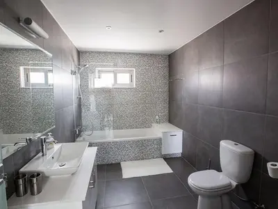 a bathroom with a toilet and a sink and a tub at Villa Ioanni Chrysos - Luxury And New 6 Bedroom Protaras Villa in Protaras
