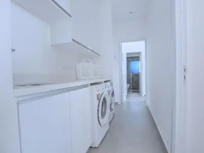 a white laundry room with a washer and dryer at Villa Limni Dyo - Luxurious Contemporary 3 Bedroom Villa With Sea Views And Hot in Paralimni