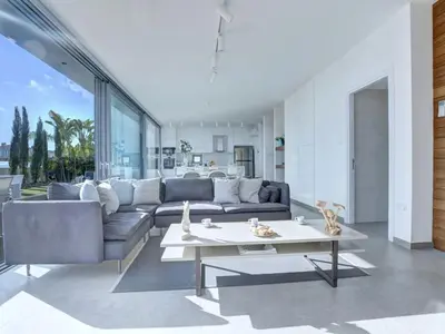 a living room with a couch and a table at Villa Limni Dyo - Luxurious Contemporary 3 Bedroom Villa With Sea Views And Hot in Paralimni